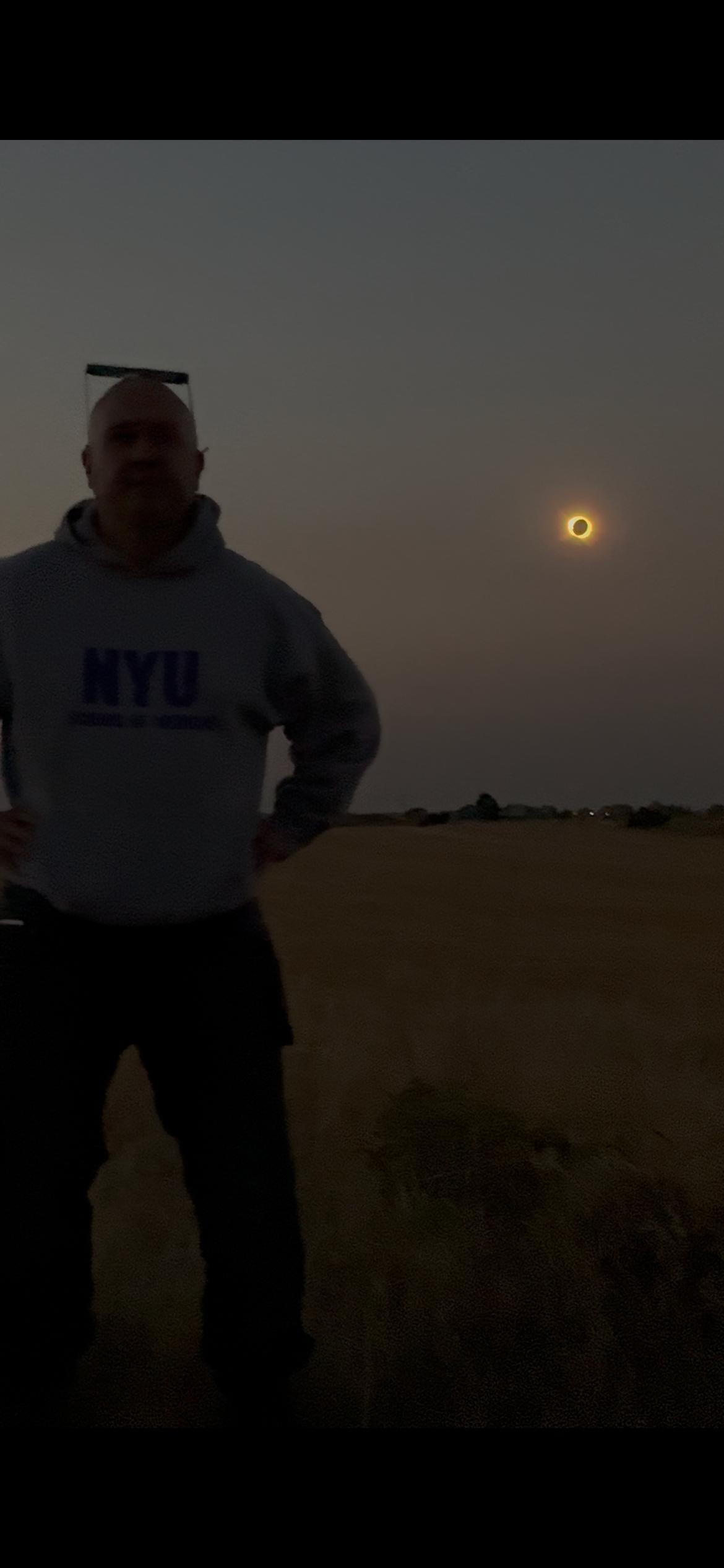 Anescribe® physician-owner standing outdoors during a solar eclipse